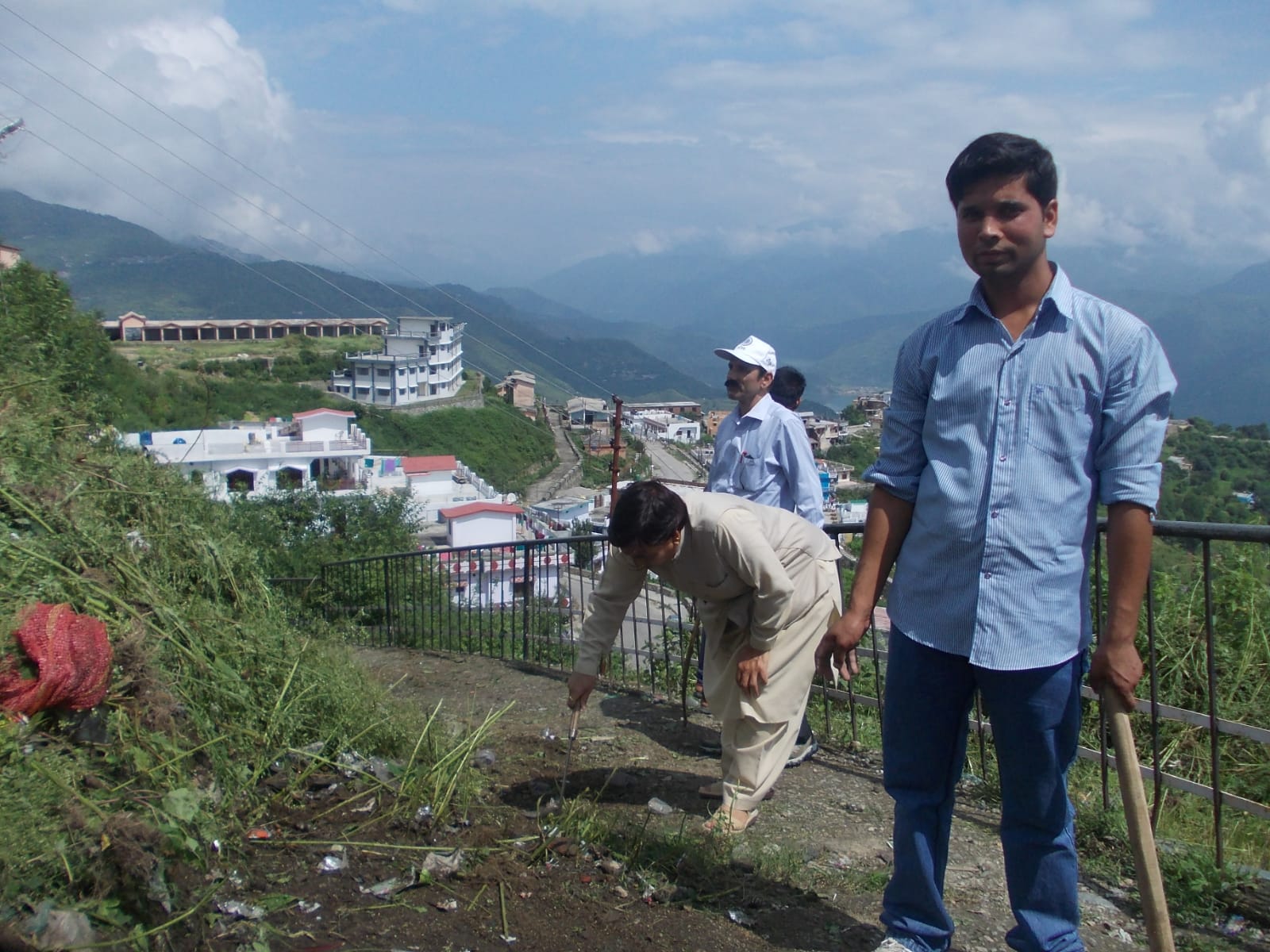 Hillside tree-plantation drive above a Himalayan town by Nehru Yuva Kendra volunteers